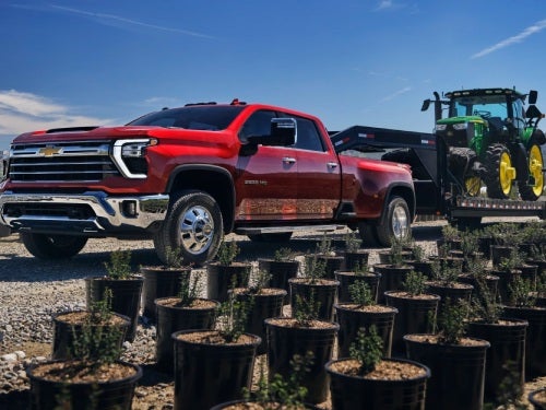 2025 Chevrolet Silverado HD towing a tractor